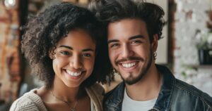A young couple embraces and smiles after dental treatment