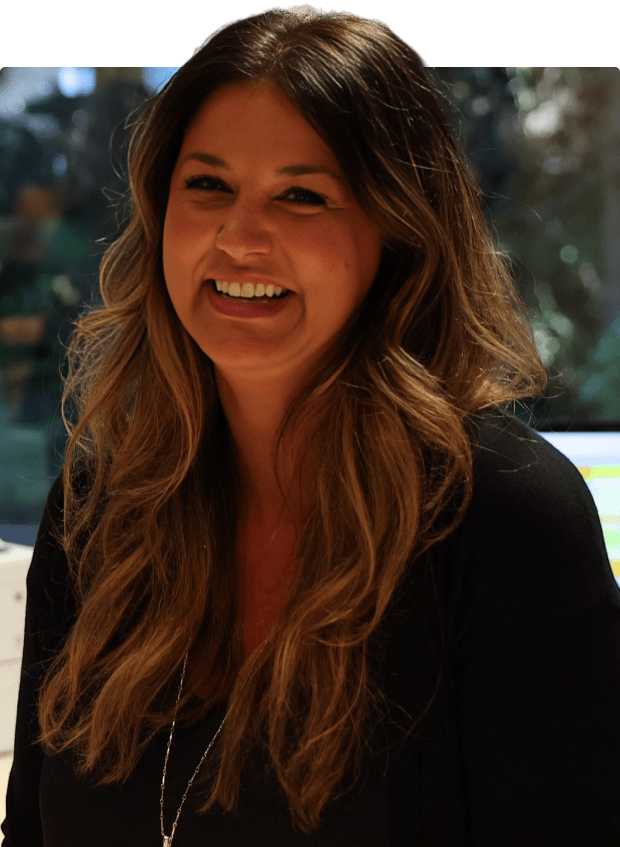 A woman is happily smiling on the street