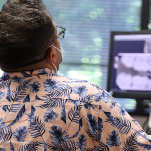 Dental patient with his dentist behind him