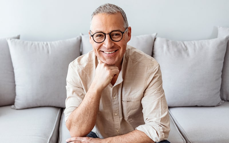 A man embraces and smiles after dental treatment