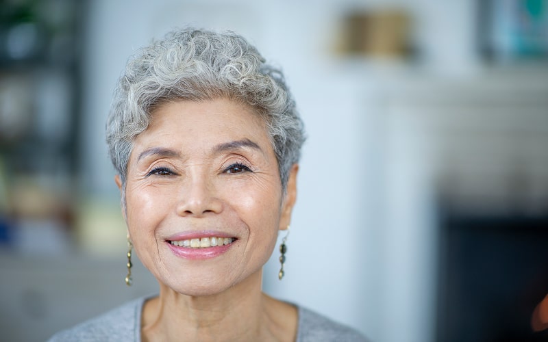 Mature couple embrace and smile after his dental treatment